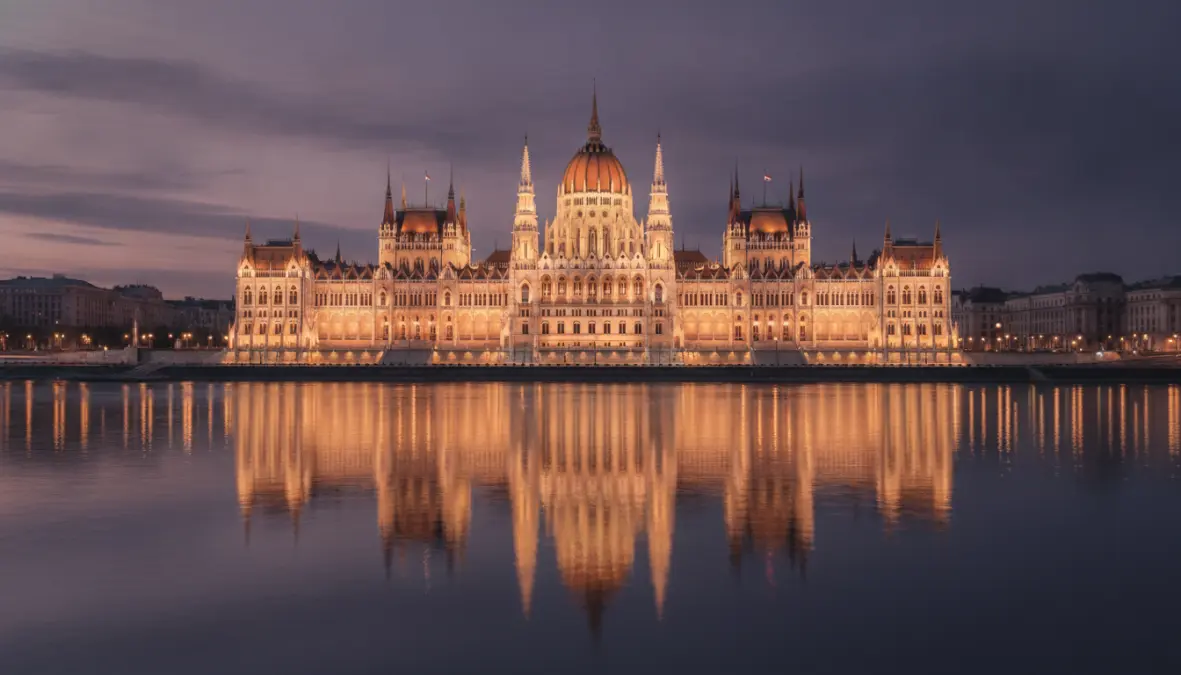 Budapest Parliament building at blue hour reflected in Danube, architectural photography Europe